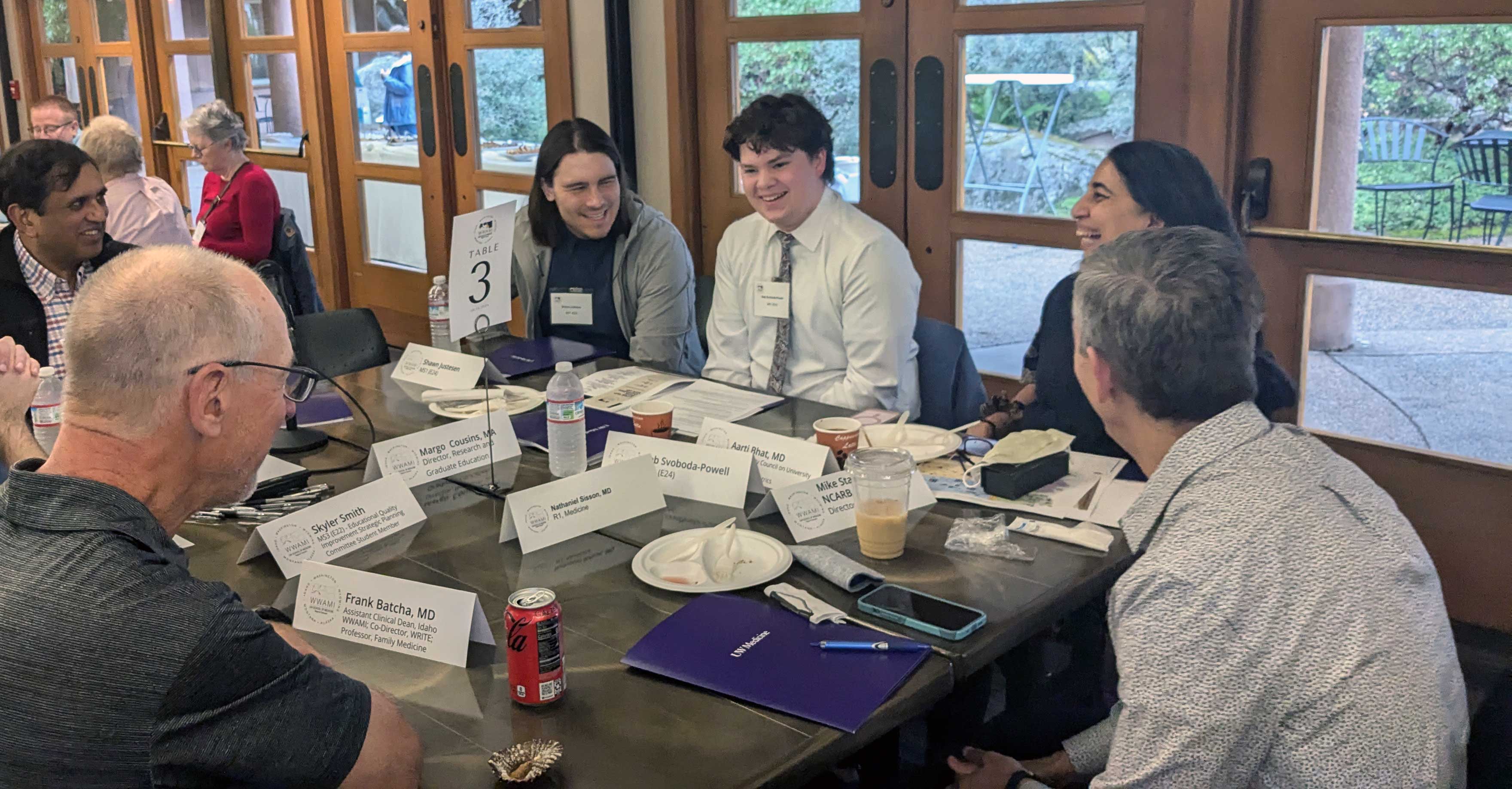 small group of people chatting around a table