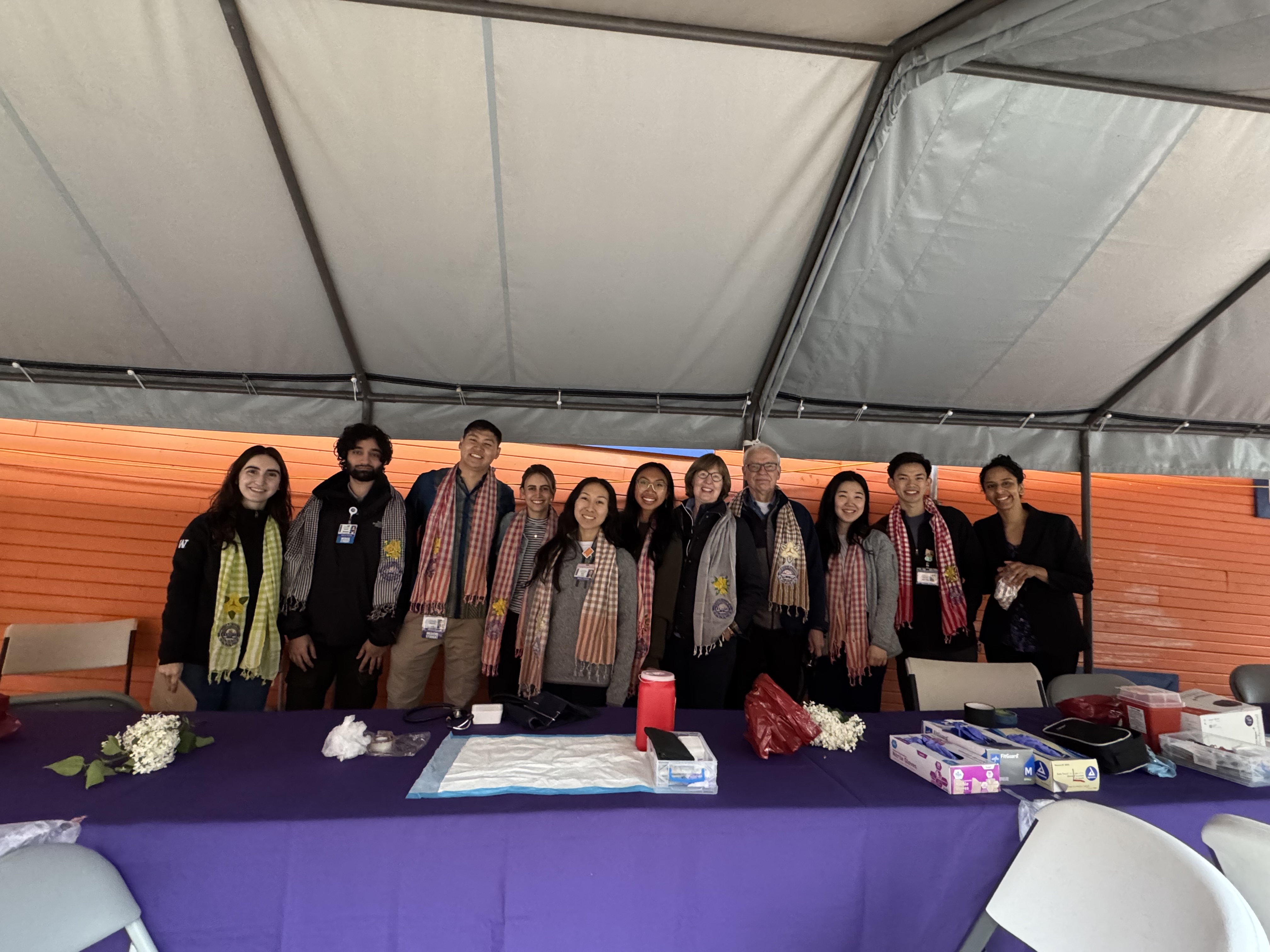The UW School of Medicine students who volunteered at the Khmer New Year Health Fair pose together behind their screening station