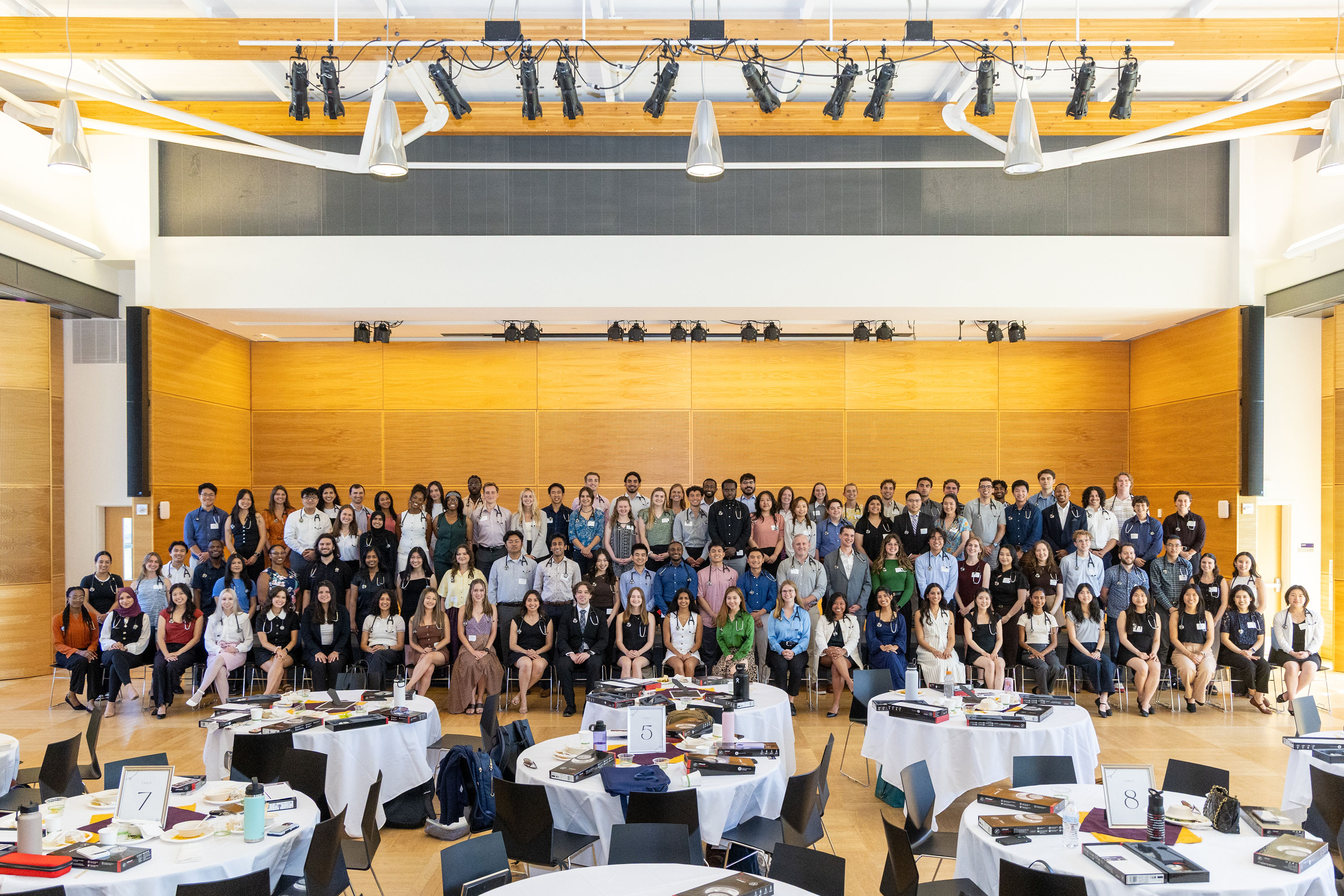 A group photo featuring the incoming class of medical students at the University of Washington Seattle Campus. They are posed in a ballroom.