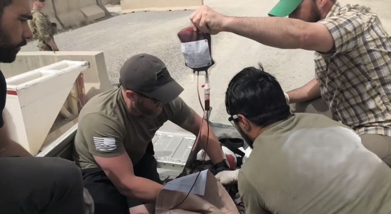 A group of military service members providing medical care