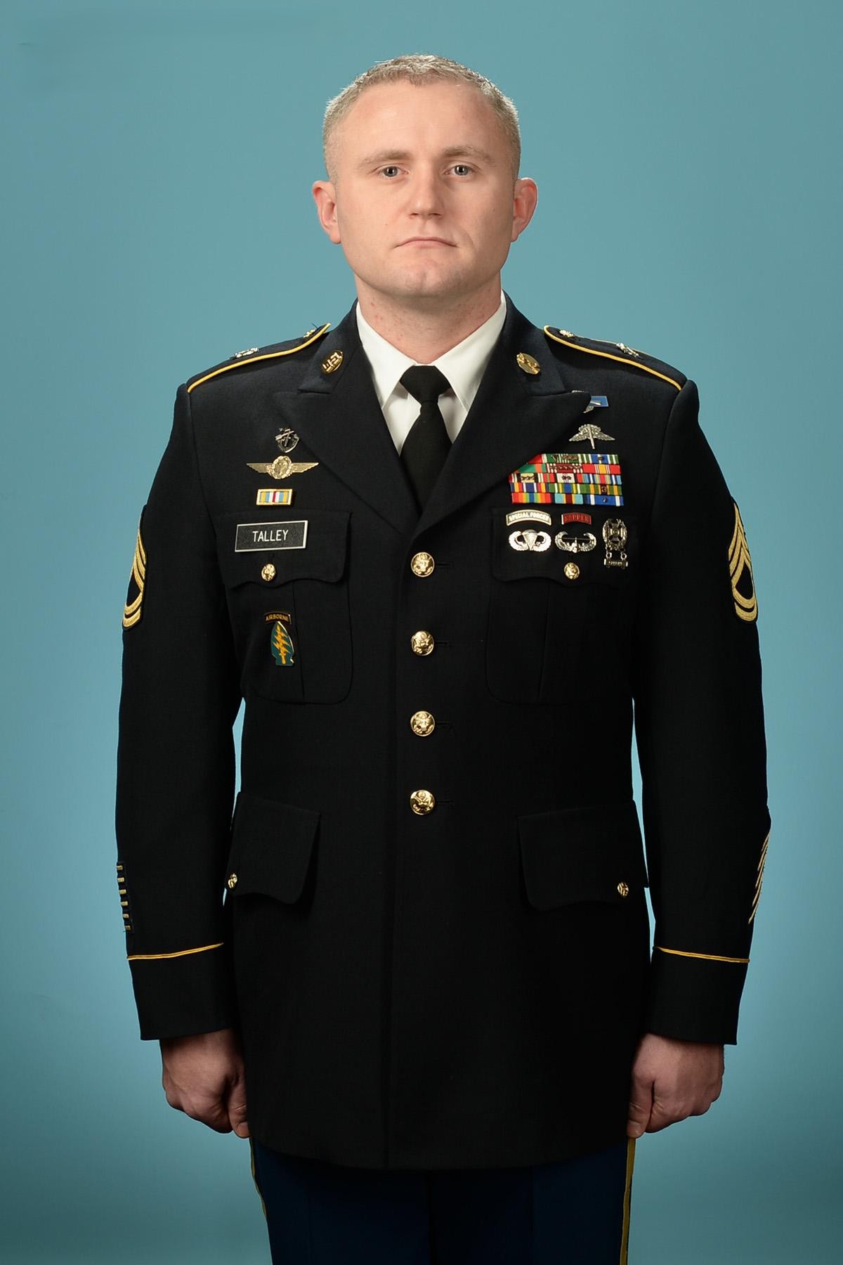 A photo of Nick Talley in full military uniform against a teal background.