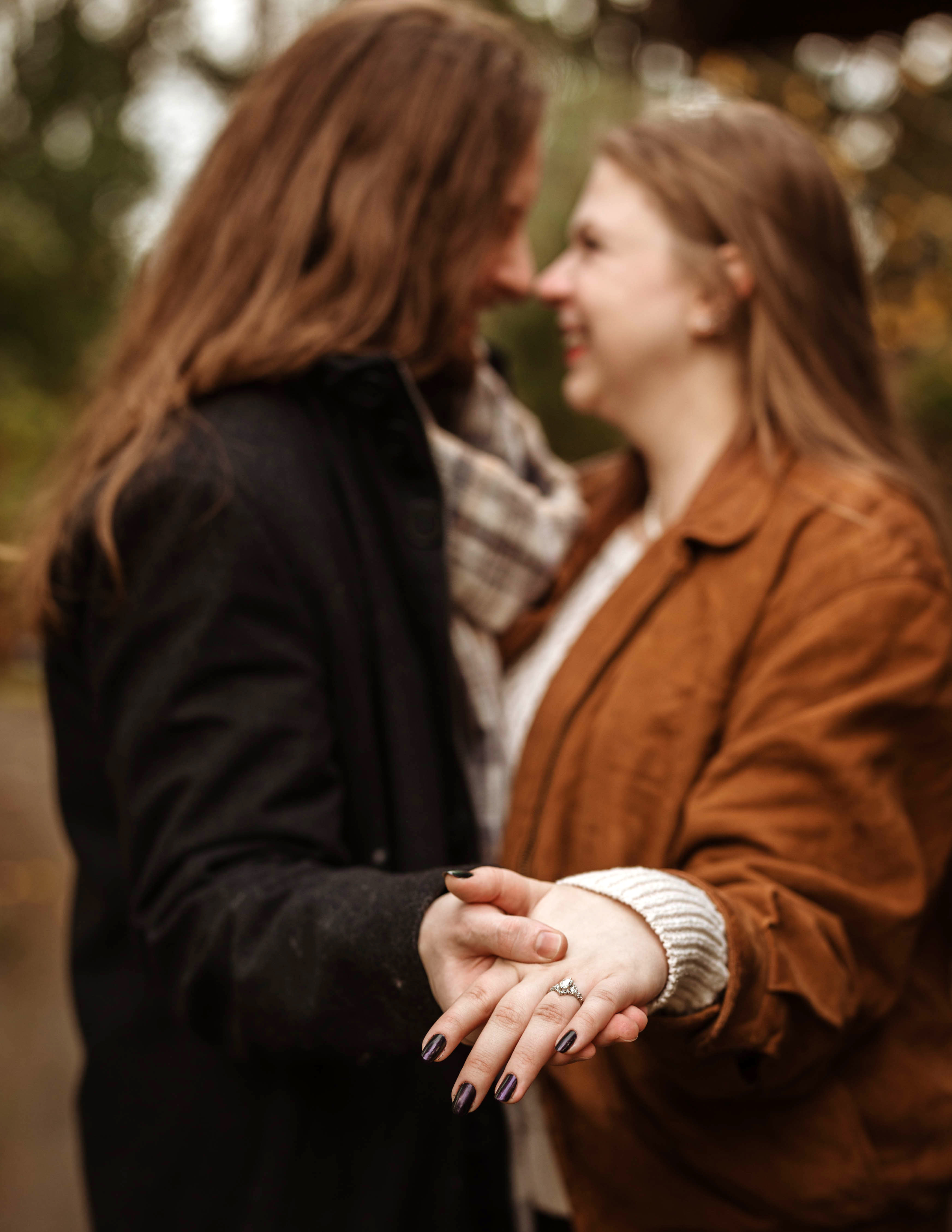 Chey and Colton hold hands with their faces pressed close together as they show off their new engagement rings 
