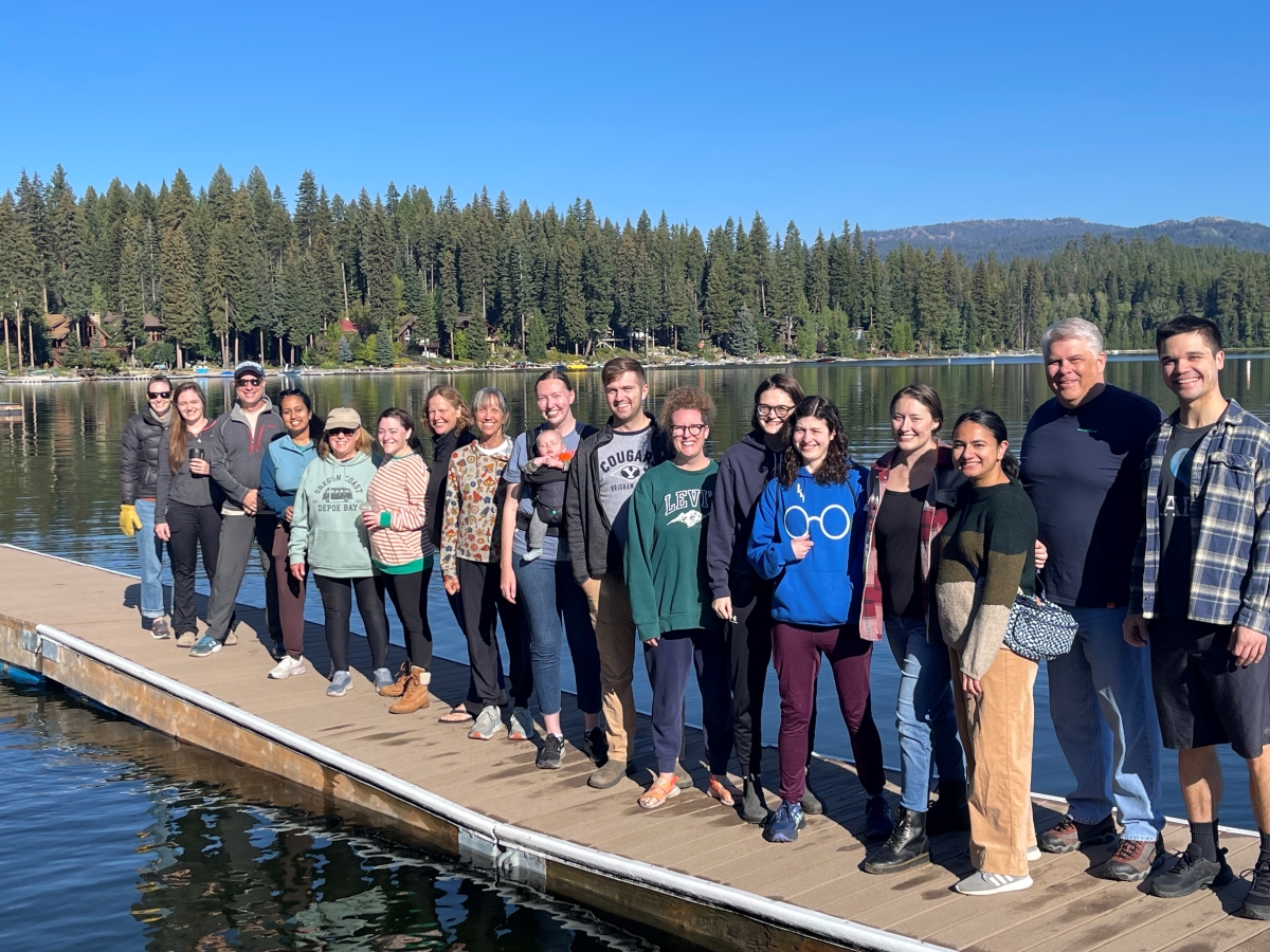 A group photo of people standing on a dock