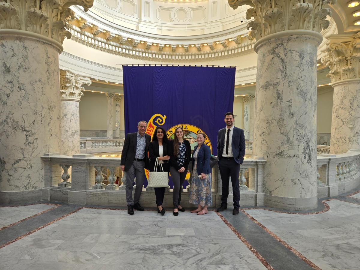 Five people pose together inside the Idaho State Capitol Building