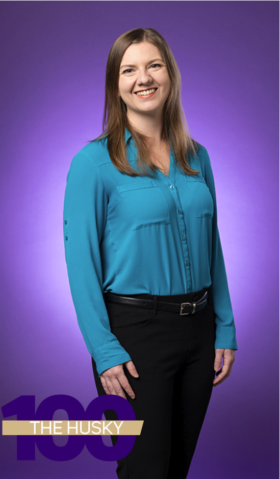 A full-body photo of Kristin Weinstein in front of a purple backgroud