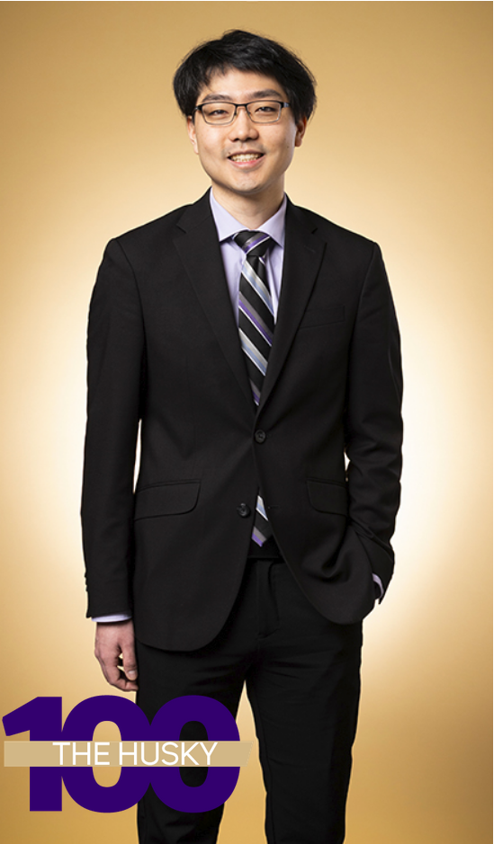A full-body photo of Hank Cheng in front of a gold background