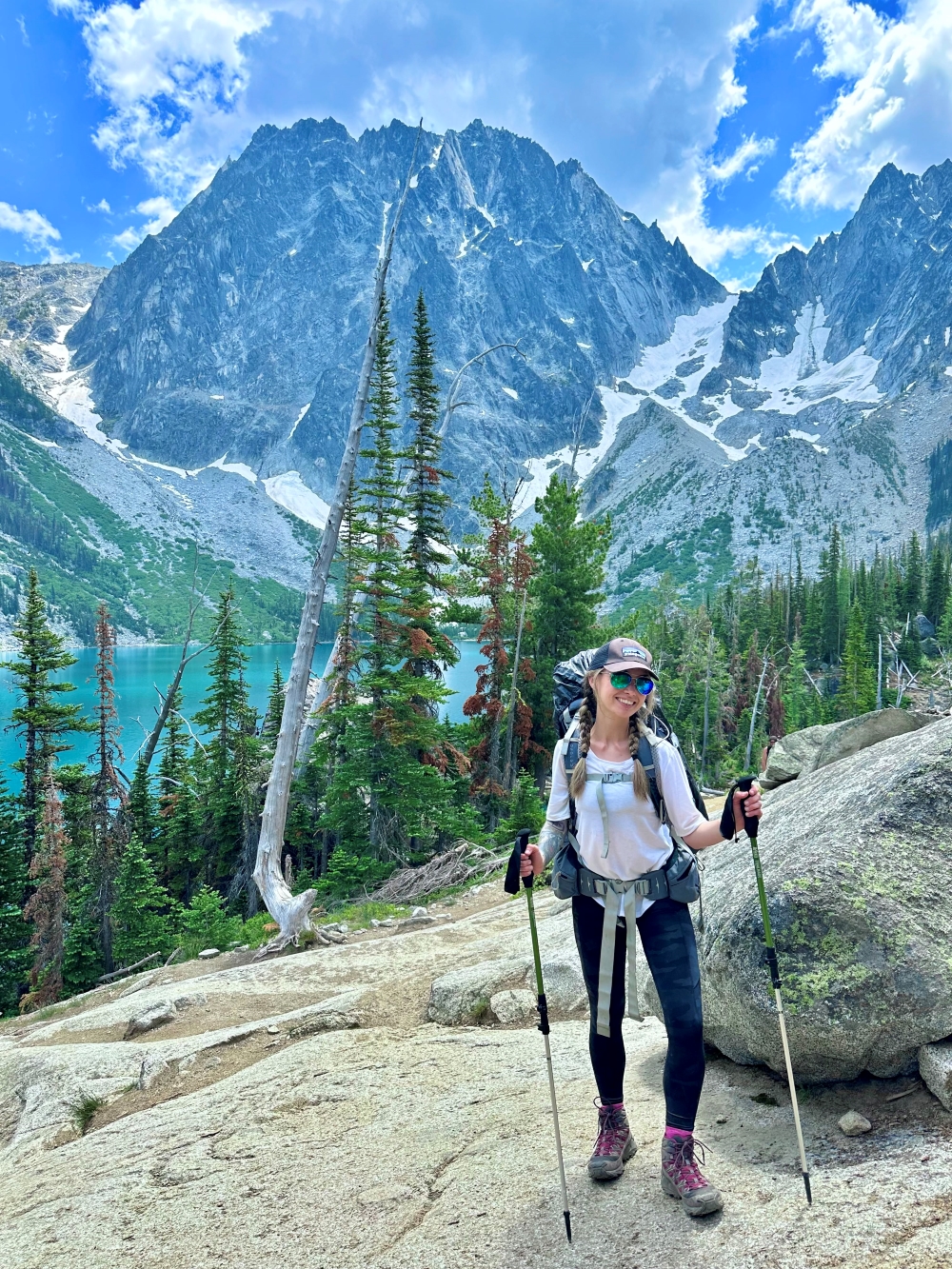 Shyanne King poses with hiking poles in front of a mountain