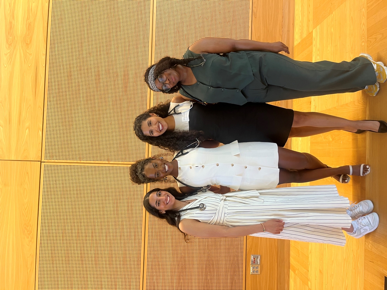 Four student doctors pose together with their new stethoscopes