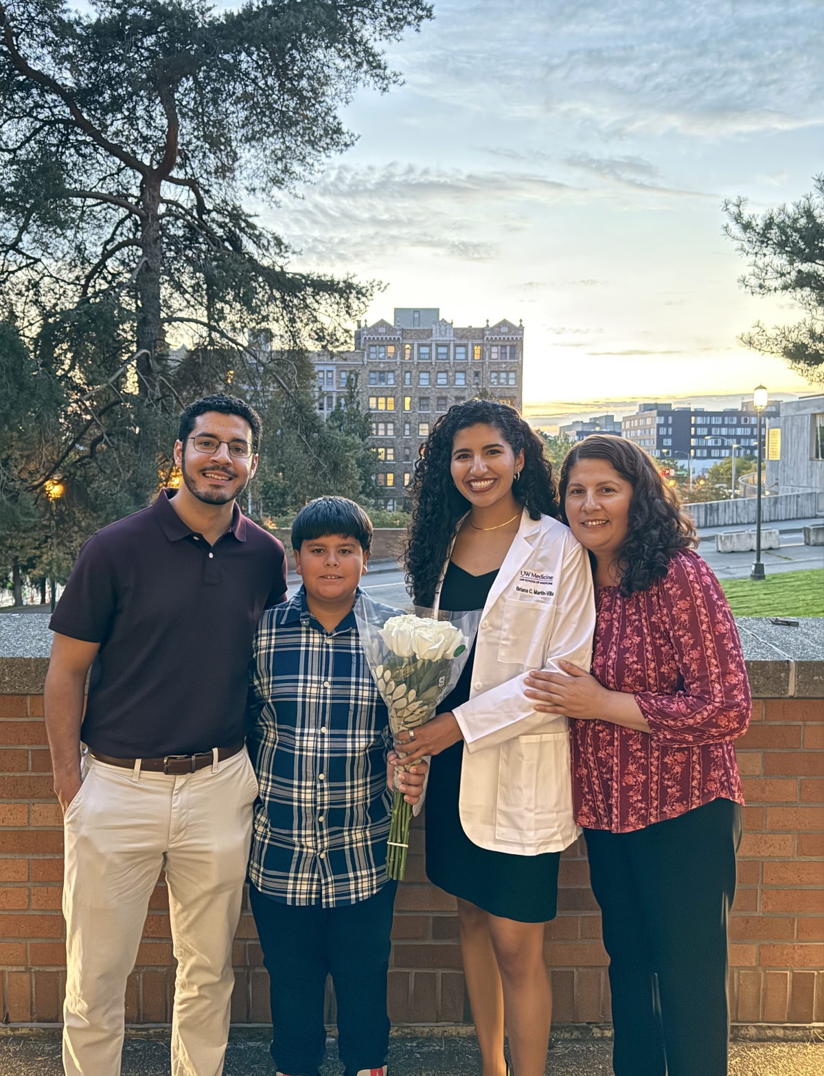 Briana Martin-Villa poses with her family in front of a city skyline