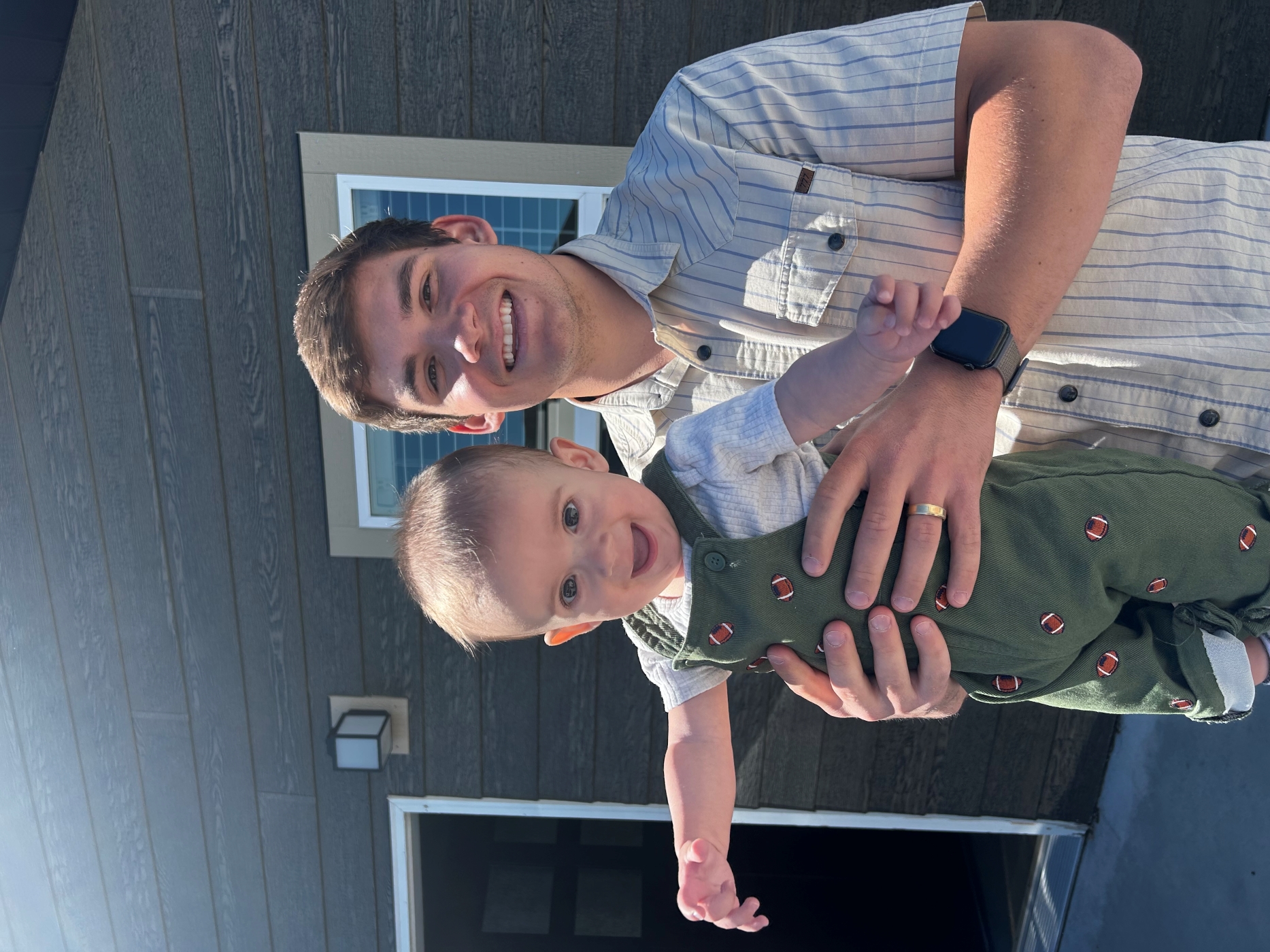 Ben Held hold his infant son, Winston
