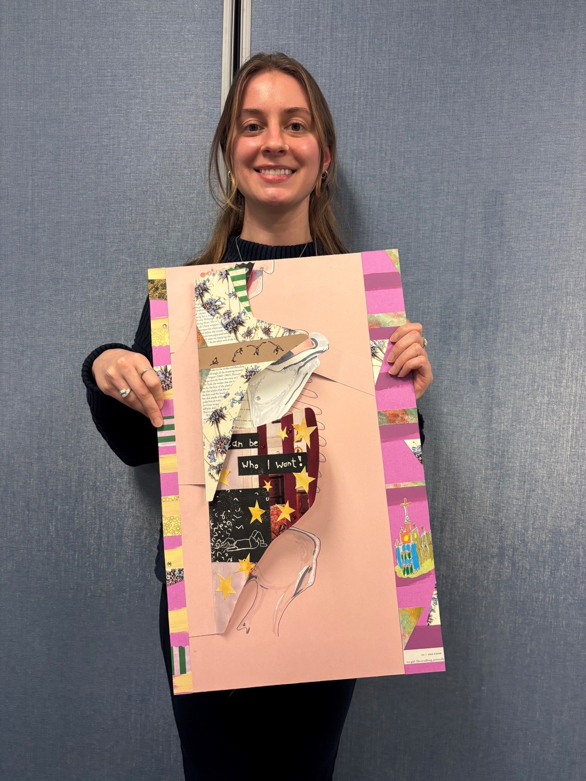 Mikaela Brandt-Fontaine poses with her project, a large pink flip-book anatomical model