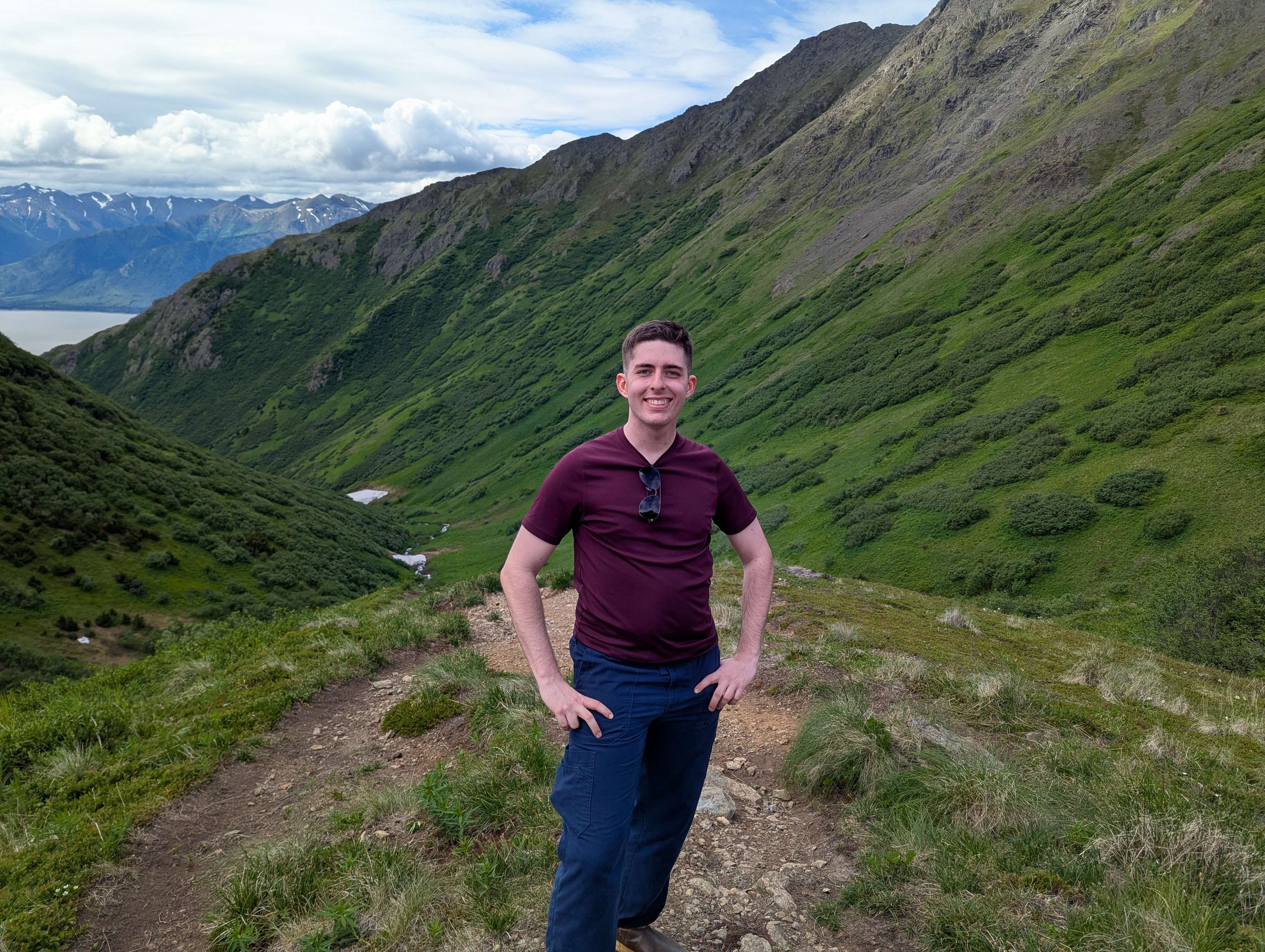 Jordan Bowling stands in front of a mountain