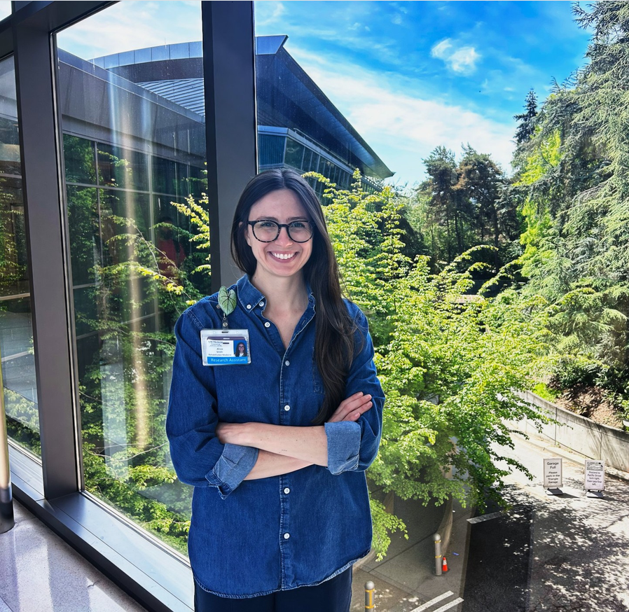 Alissa Smith poses in front of foliage