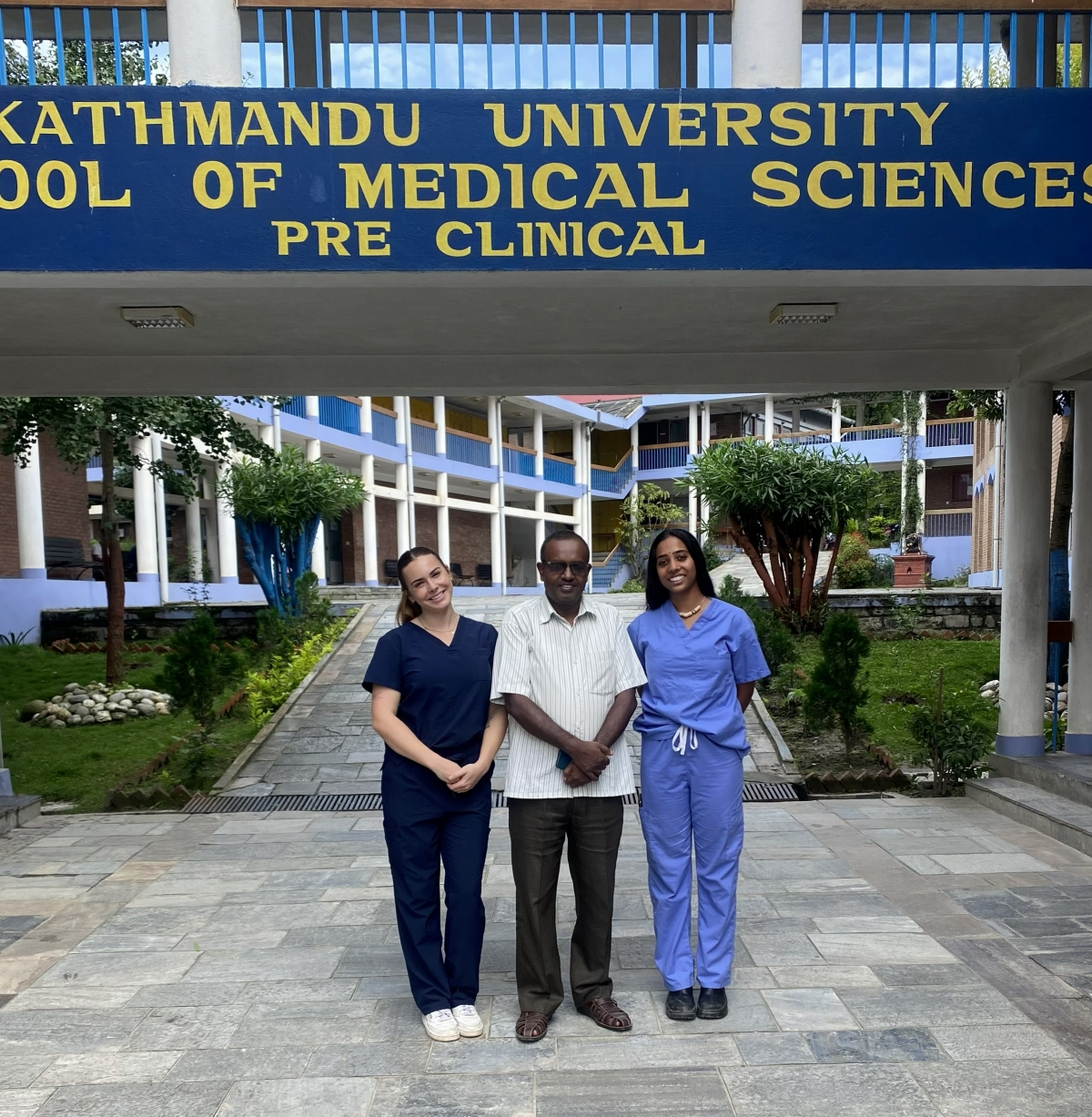 Bhargavi and a friend pose with Dr. Dil Islam Mansur in front of Kathmandu University