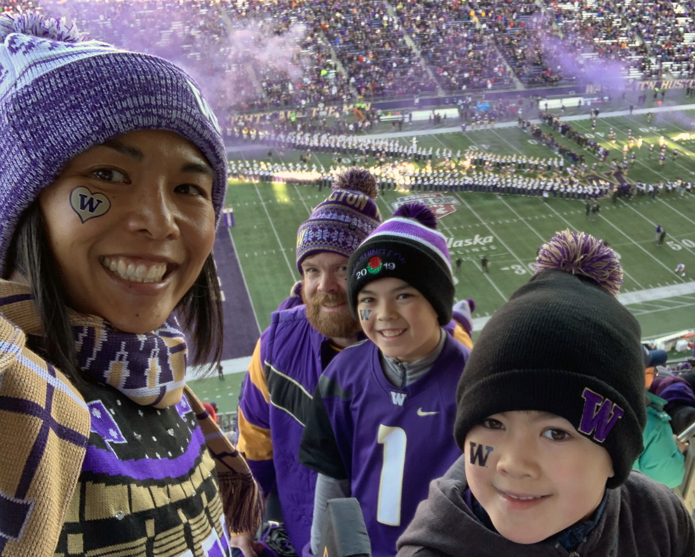 Dr. Gerrish at a Husky game with family in the stands